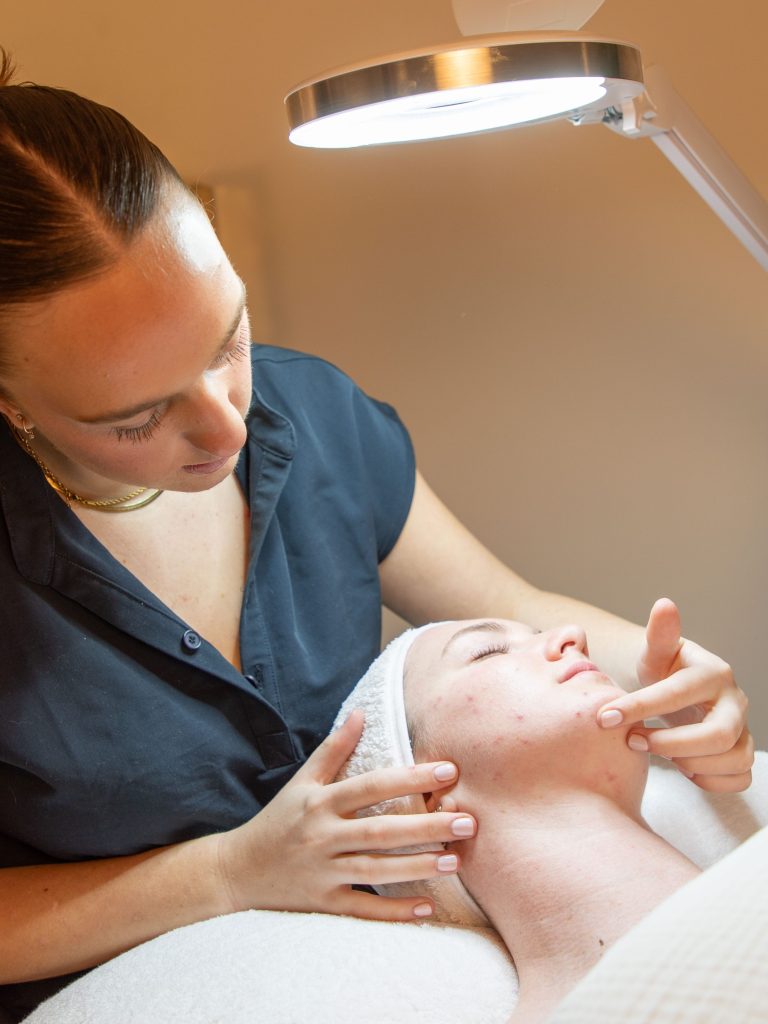 Young woman receiving facial massage